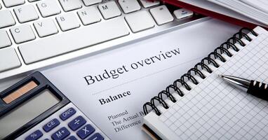document with title budget overview on the desktop photo