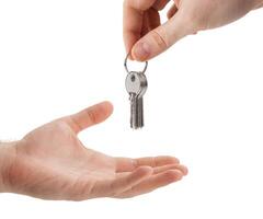hands over the keys to the apartment from hand to hand photo