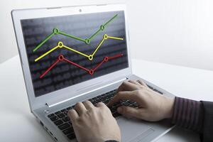 hands of a person working on a computer with graphs photo