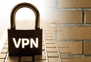 padlock with inscription VPN with the computer keyboard with brick wall Internet security photo