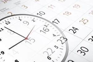 sheet of a calendar with the number of days and clock photo