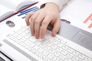 human hands on the notebook keyboard photo