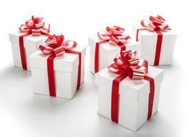 white festive gift boxes with red bows on a white photo