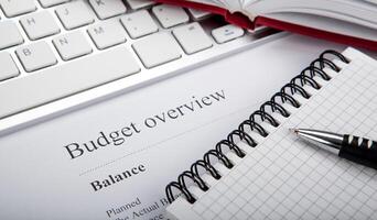 document with title budget overview on the desktop photo