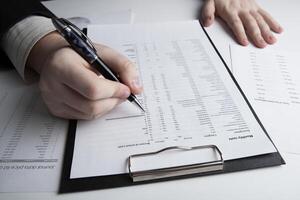 man is looking for information in the in the budget figures photo