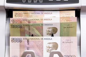 Angolan Kwanza in the counting machine photo