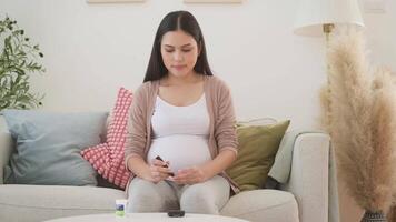 Pregnant woman checking blood sugar level by using Digital Glucose meter video