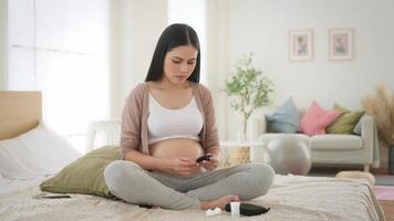 Pregnant woman checking blood sugar level by using Digital Glucose meter video