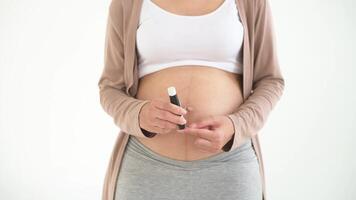 Pregnant woman checking blood sugar level by using Digital Glucose meter video