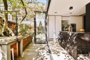 A kitchen with a large window and a bar photo