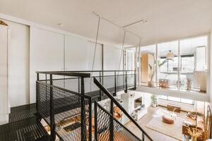A loft with a staircase and a balcony photo