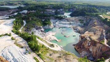 An aerial view of a quarry with water and trees video