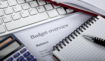 document with title budget overview on the desktop photo