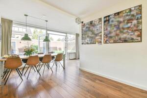 A dining room with a table and chairs photo