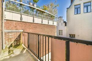 A balcony with a railing and a fence photo