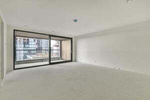 An empty room with a sliding glass door photo