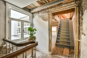 A stairway leads to a room with a window photo