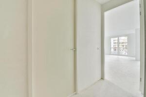 A white room with a door and a window photo