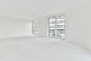 An empty room with white walls and large windows photo