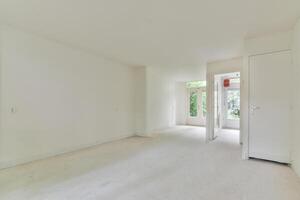 A white room with a door and a window photo