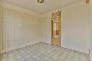 An empty room with a door and a window photo