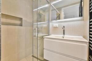 A bathroom with a sink and a shower stall photo