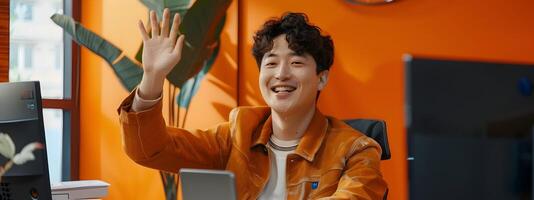 Energetic Young Korean Man Waving During Call in Modern Office Setting with Neo Pop Aesthetic photo