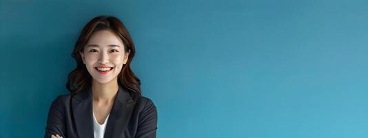 Confident and Accomplished Hallyu Businesswoman Stands in Stylish Suit Against Vibrant Blue Background photo