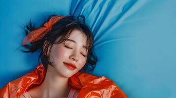 Captivating Hallyu Woman in Modern Costume Resting on Blue Background photo