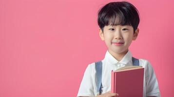 Cheerful Young Korean Boy Holding Book and Smiling in Modern Stylish Costume photo