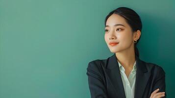Confident Asian Businesswoman in Modern Style Relaxing on Green Background photo