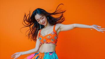Energetic Asian Dancer in Trendy Pop Art Style Portrait on Vibrant Orange Background photo