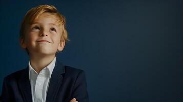 A young boy in a suit and tie looking up photo