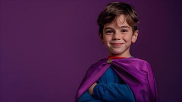 A young boy in a purple cape posing for the camera photo