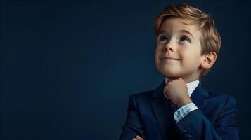 Pensive Young Professional Smiling Boy in Modern Business Suit on Navy Background photo