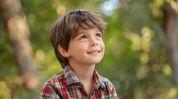 A young boy is smiling while looking up photo