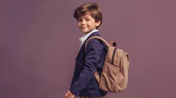 Smiling 7 Year Old Boy in School Uniform Walking with Backpack on Plum Background photo
