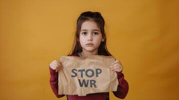 Sorrowful Child Protesting War with Banner on Mustard Backdrop photo