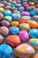 Colorful assorted natural pebbles and stones arranged in a vivid,textured display photo