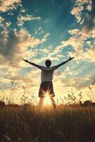 Silhouetted Figure Enjoying Serene Sunset in Meadow photo