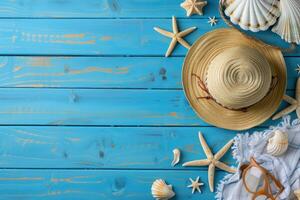 Summer background with hat, sunglasses, seashells and starfish on blue wooden background photo