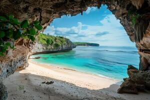 The beach is in front of a cave in the middle of the ocean photo