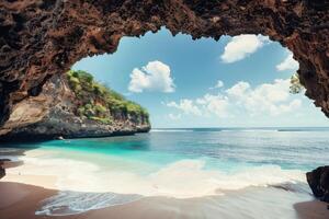 Beautiful beach and sea view from inside a cave in bali, indonesia photo