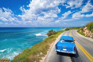 A classic car drives along the coast of cuba photo