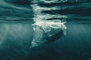 Plastic bag floating in the ocean photo