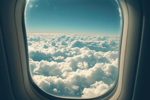 An airplane window looking out at the sky photo