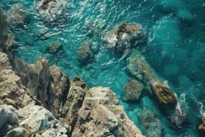 Rocky coast line with turquoise water and rocks photo