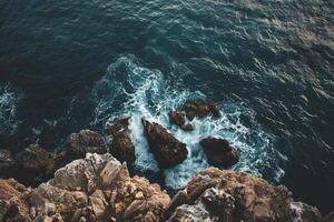 Rocky coast of the sea with waves and rocks photo