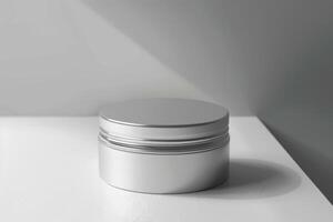 A silver container with a lid sitting on a table photo