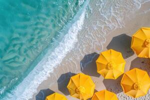 A view of several yellow umbrellas on a beach photo